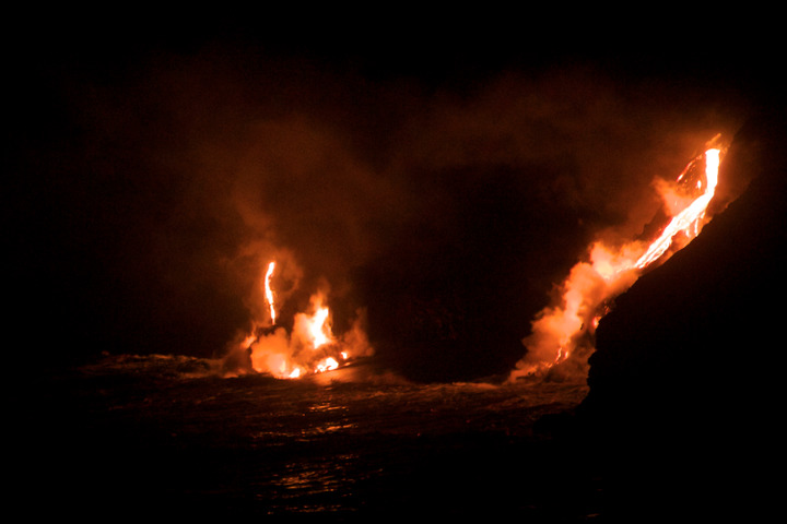 Lava from the Mount Kilauea volcano flows into the Pacific Ocean at night, March 1, 2013.