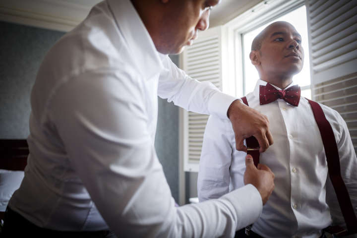African American Gay Groom Gets readdy for wedding at Hilton Orrinton Hotel in Evanston Illinois
