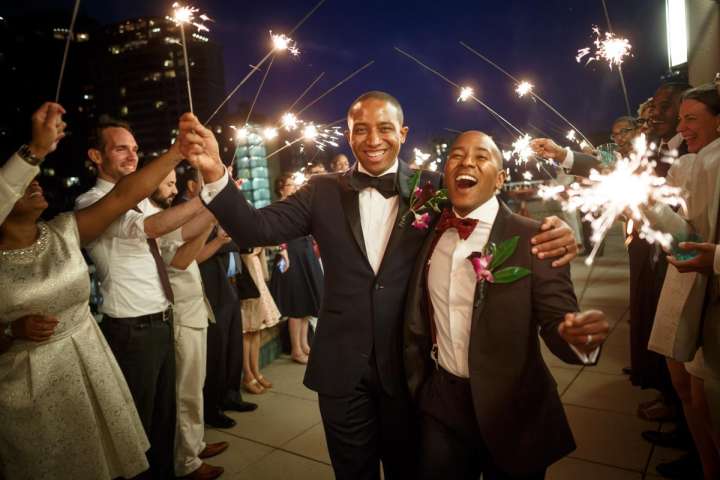 Evanston Gay Wedding photographer Ramon & Cecil arrive at their cocktail hour with sparklers in hand.