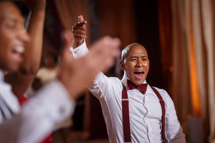 Evanston Gay Wedding photographer african american groom dances