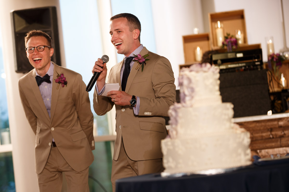 Gay couple welcomes guest to their wedding reception at the Peggy Notebaert Nature Museum in Chicago