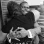Goom hugs guest by Chicago Black & White Gay Wedding Photographer