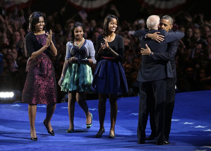 U.S. President Barack Obama hugs Vice President Joe Biden as the first family looks on to during their election night victory rally in Chicago, November 7, 2012. REUTERS/John Gress