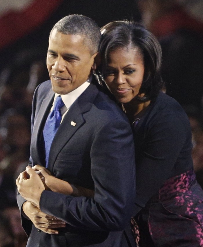 U.S. President Barack Obama is embraced by first lady Michelle Obama after his victory speech during his election night rally in Chicago, November 6, 2012. REUTERS/John Gress