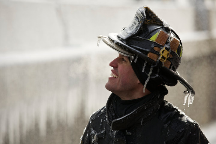 Chicago Firefighter Michael De Jesus is covered in ice as he mans a water cannon while fighting a warehouse fire January 24, 2013, which caught fire Tuesday night in Chicago. Fire Department officials said it is the biggest fire the department has had to battle in years. One-third of all Chicago firefighters were on the scene at one point or another trying to put out the flames. REUTERS/John Gress (UNITED STATES)