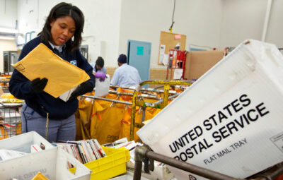 United States Postal Service Letter Carrier Lakesha Dortch-Hardy sorts mail at the Lincoln Park carriers annex in Chicago, November 29, 2012. REUTERS/John Gress (UNITED STATES)