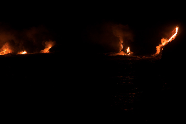 Lava from the Mount Kilauea volcano flows into the Pacific Ocean at night, March 1, 2013.