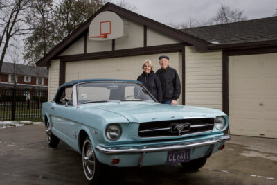 Tom (L) and Gail Wise pose with Gail's Skylight Blue 1964 1/2 Ford Mustang convertible outside their garage where it sat for 27 years before its restoration, in Park Ridge, Illinois November 26, 2013. Gail Wise, then using her maiden name of Gail Brown, made the first known retail purchase of a Mustang on April 15, 1964, two days before the model went on sale. Ford will unveil its next-generation 2015 Mustang on December 5, 2013 for the model's 50th anniversary with simultaneous events in Michigan, Shanghai, Sydney, Barcelona, New York and Los Angeles.
