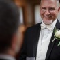 Gay grooms smile before their chicago wedding.