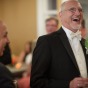 Gay groom laughs during gay wedding in Chicago