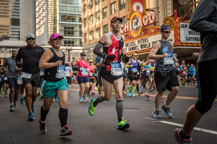 Runners pass the Chicago theatre during the Chicago Marathon