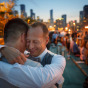 Gay grooms embrace at the end of their LGBT wedding in Chicago