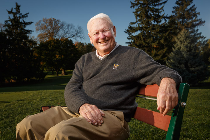 Madison Portrait Photographer Dr. David Cookson poses while seated on a bench