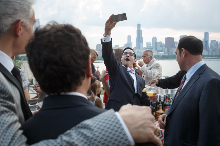 A gay wedding guest takes a selfie in Chicago