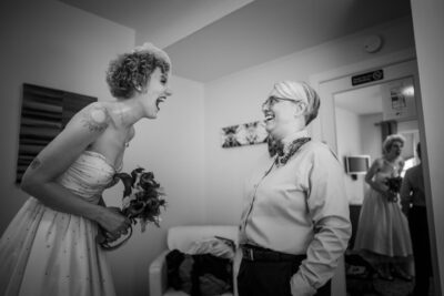 Lesbian bride laughs with matron of honor