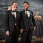 gay grooms smile after wedding in Chicago Illinois