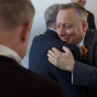 Illinois Gay Wedding Photographer captures groom hugging guest in Chicago