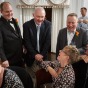 Family memebers laugh with gay grooms during their Chicago wedding