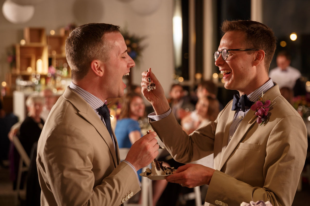 Gay couple curring the Cake during a wedding at the Peggy Notebaert Nature Museum in Chicago