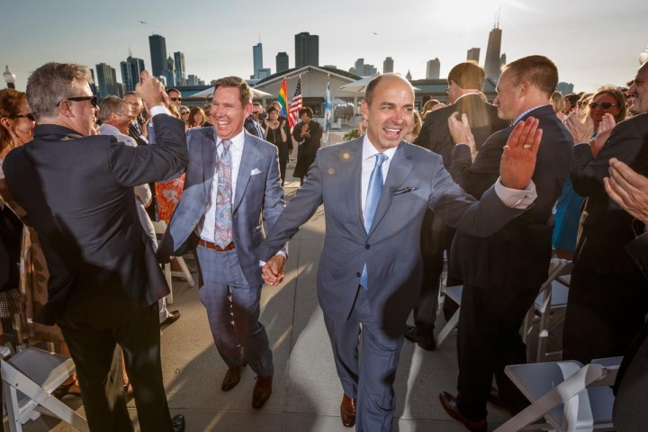 Illinois same-sex wedding photographer grooms leave wedding ceremony at Navy Pier