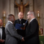 grooms at the alter during religious gay wedding in Chicago