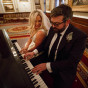 Chicago wedding photographer couple play the piano before their wedding ceremony