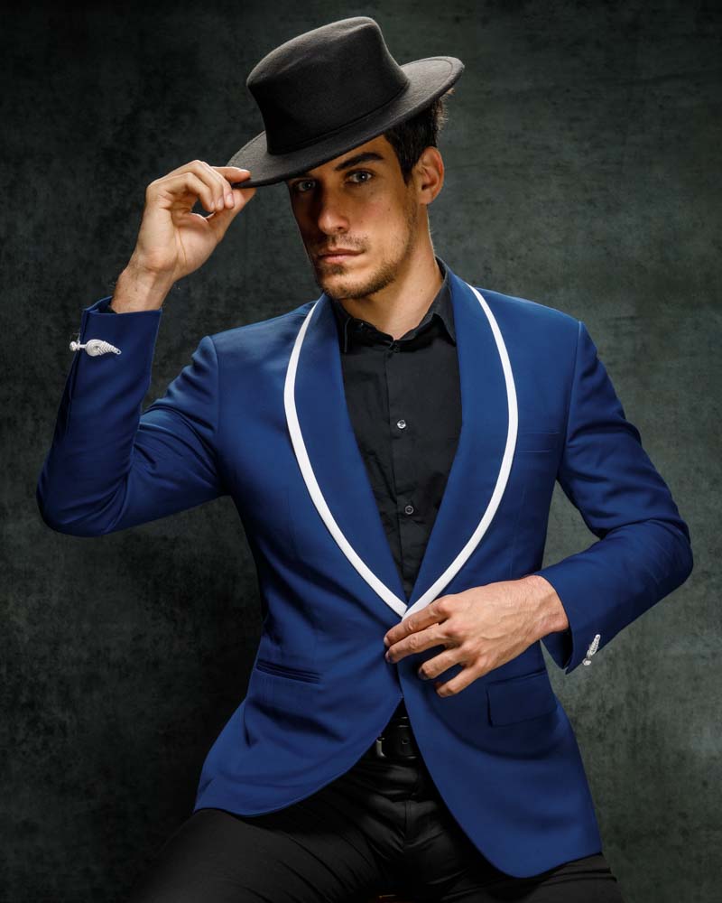 male model wearing a blue tuxedo with a black hat