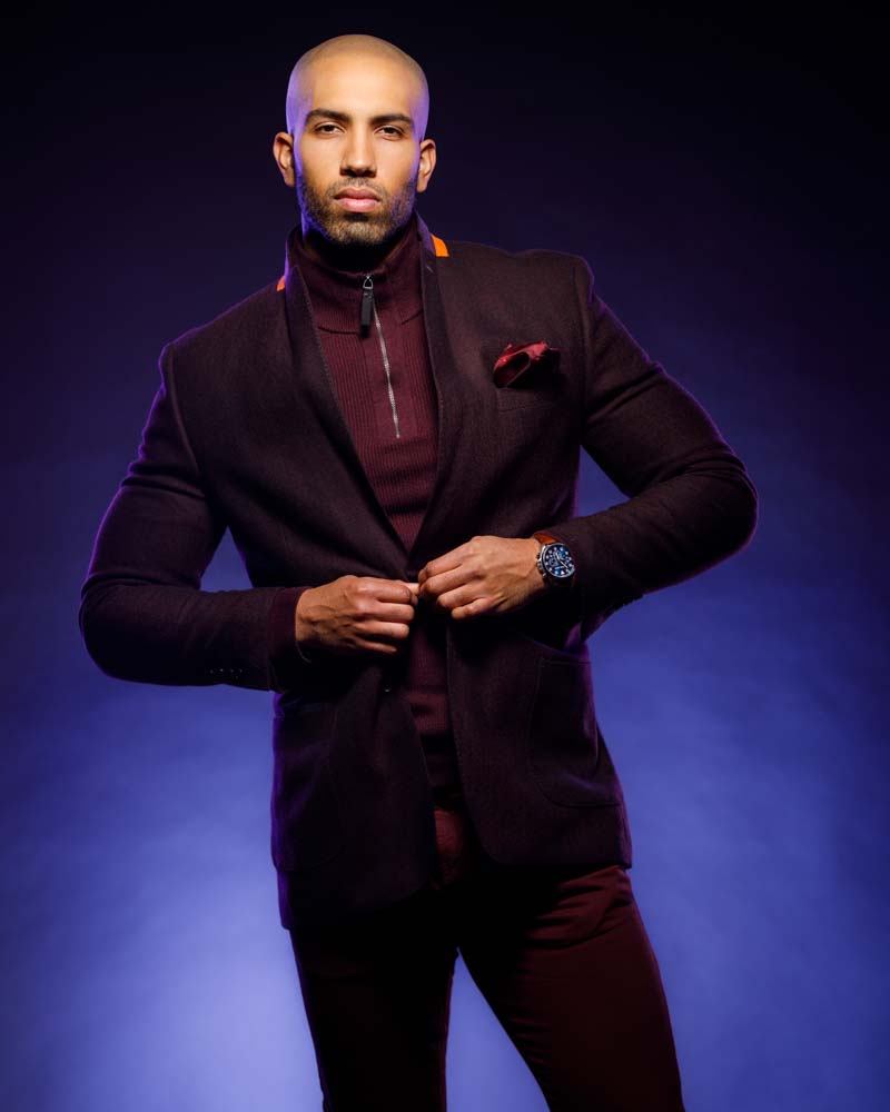 male model in front of purple backdrop that a had a gradient and purple edge lighting