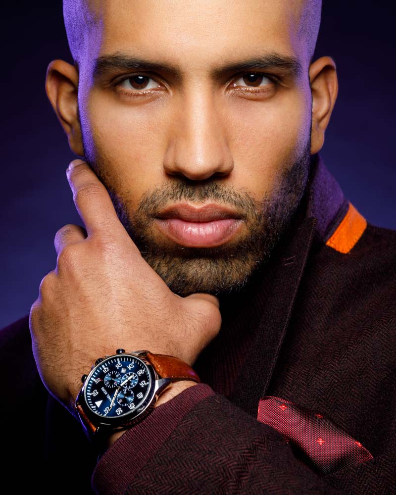 male model in front of purple backdrop that a had a gradient and purple edge lighting headshot