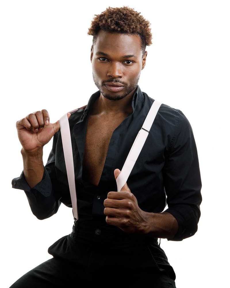 Male model on white backdrop wearing white suspenders