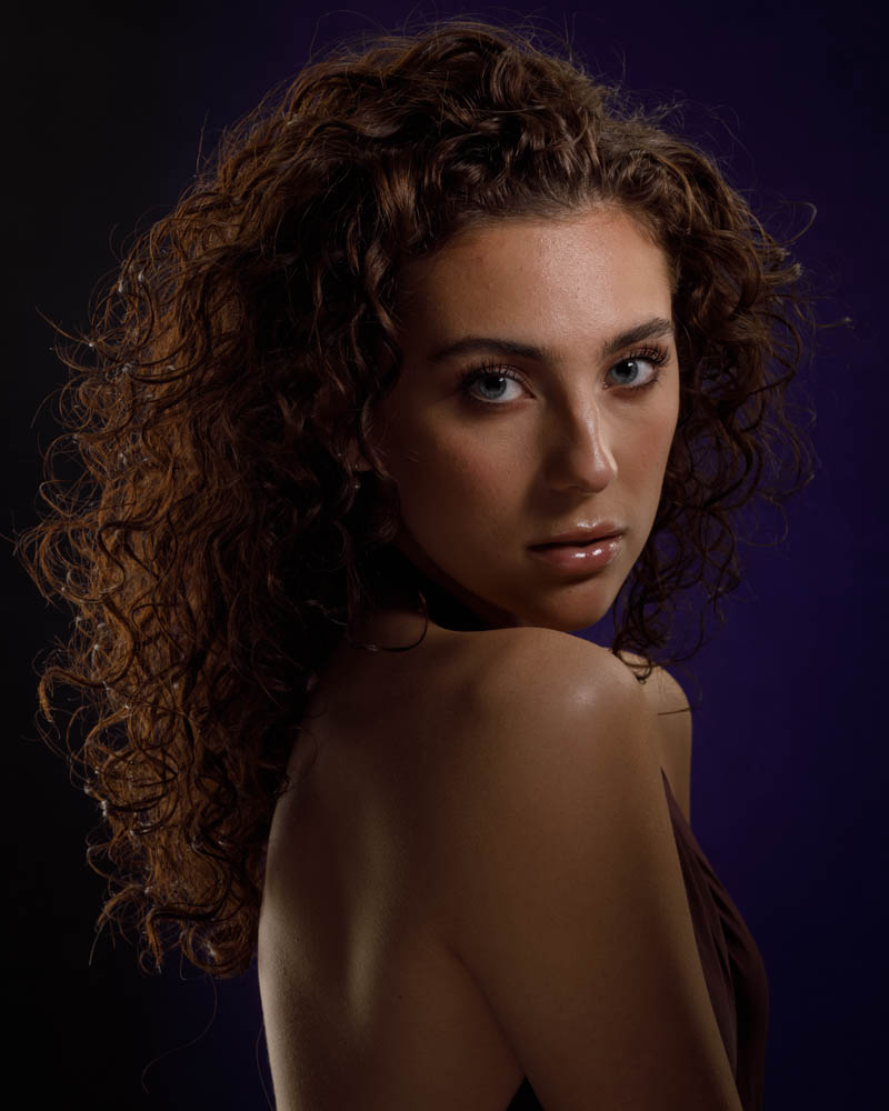 female model headshot purple backdrop