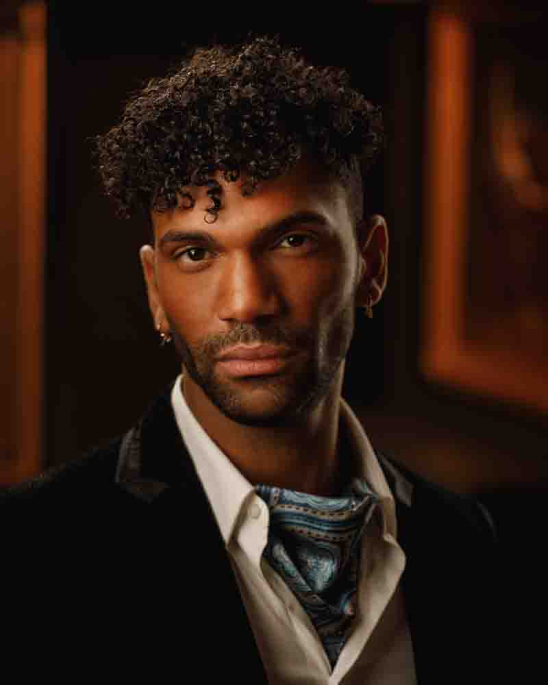 Dramatic headshot of Kahil highlighting his sharp cheekbones with expert lighting.