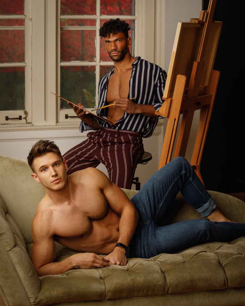 Sam posed as a model on a sofa with Kahil artistically engaging behind him, palette and brush in hand, creating a dynamic scene in their headshot session.