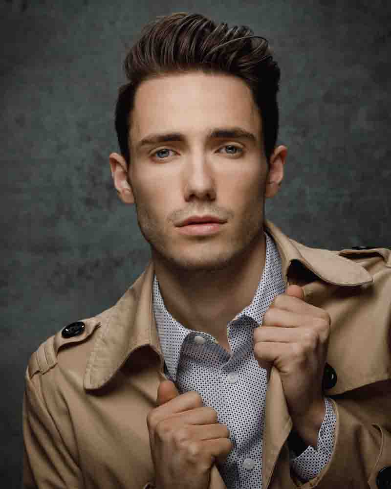 David exudes a sophisticated and timeless style in a tan trench coat, captured against a soft, professional backdrop. This headshot highlights his approachable yet polished demeanor, ideal for editorial and commercial opportunities.