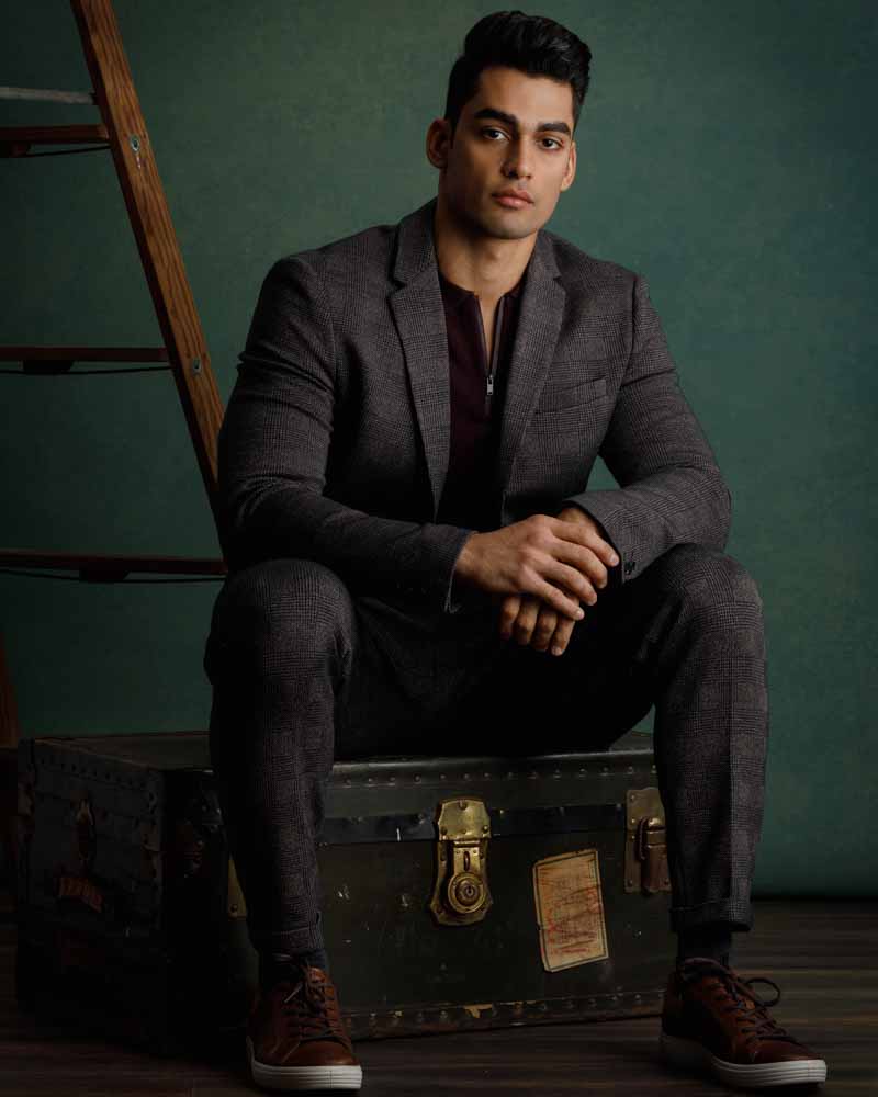 Akshay in a stylish brown plaid suit and maroon polo, embodying sophistication with a casual twist for a professional modeling portfolio.