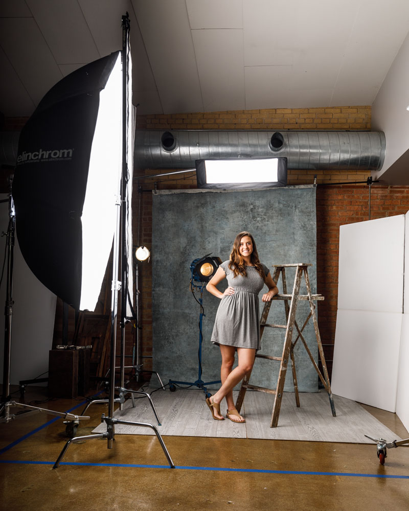 Taylor leaning on an antique ladder during her photoshoot with aspiring model photographer in Chicago