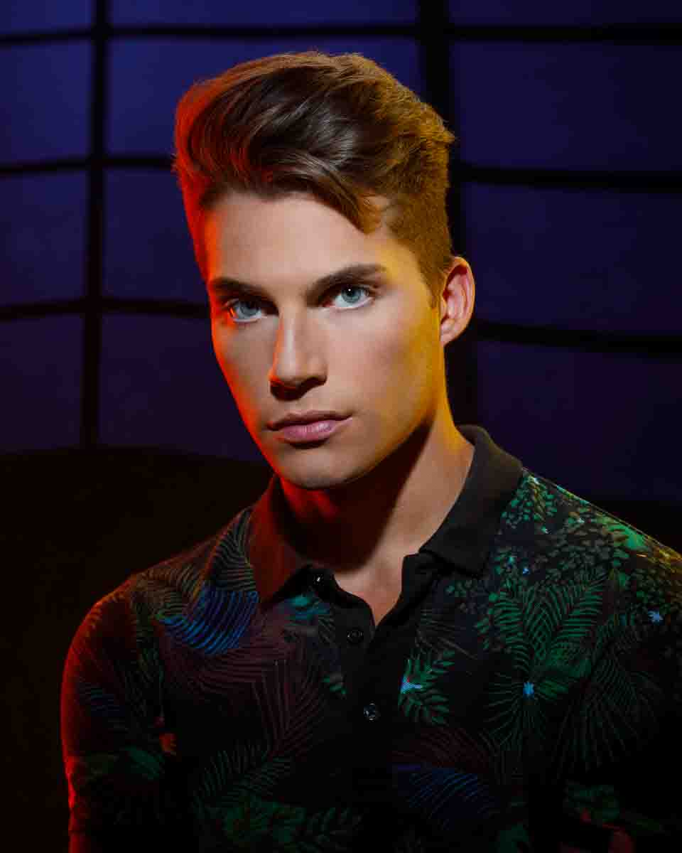 Dramatic and colorful portrait of Christian with yellow, red, and blue lighting