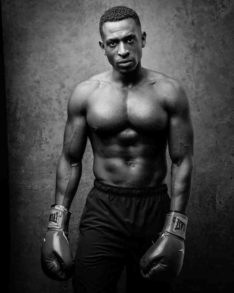 Artistic three-quarter view of Teagan in boxing gear, demonstrating the art of fitness photography by Chicago based photographers