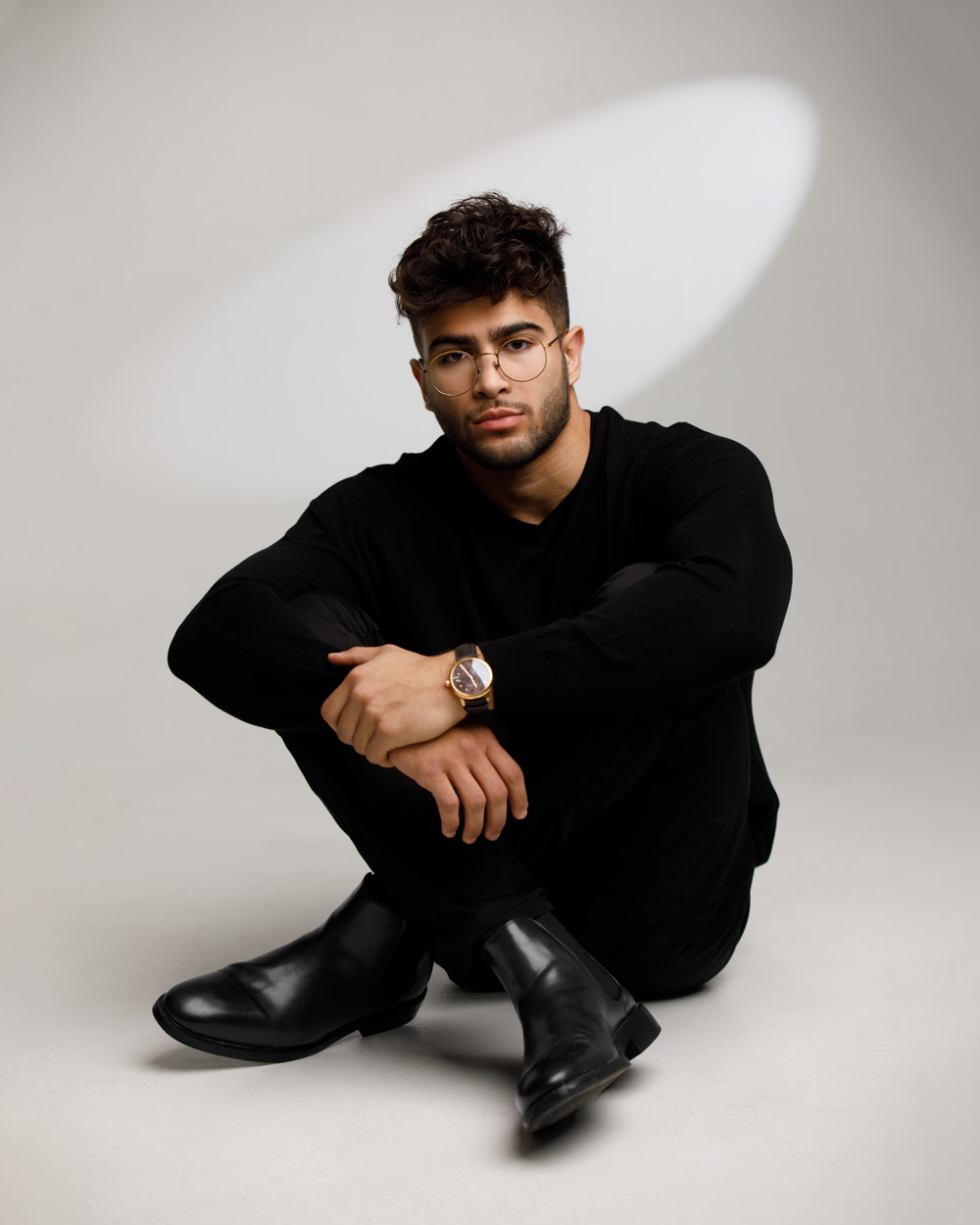 Full body portrait of Muhammed in all black attire at a Chicago photo studio