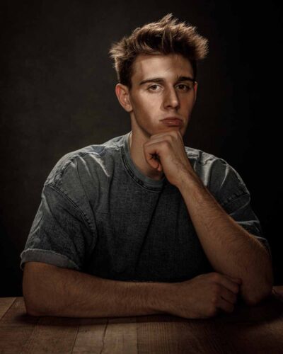 Jonathan at a rustic table at a Chicago model photography studio.