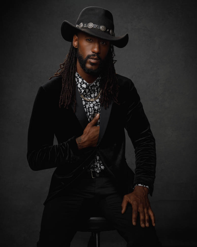 Matthew wearing a bold patterned shirt and cowboy hat, adding a unique flair to his portfolio as captured by Chicago portrait photographer.