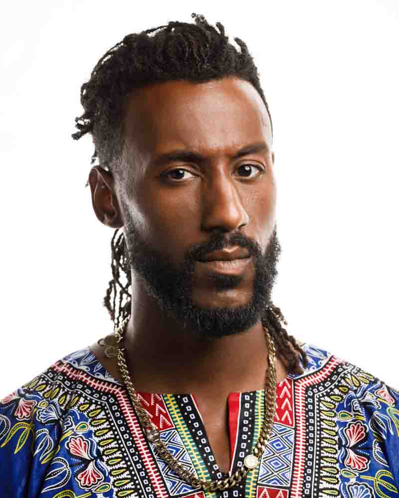 Matthew dressed in colorful traditional African attire, showcasing cultural diversity and style.