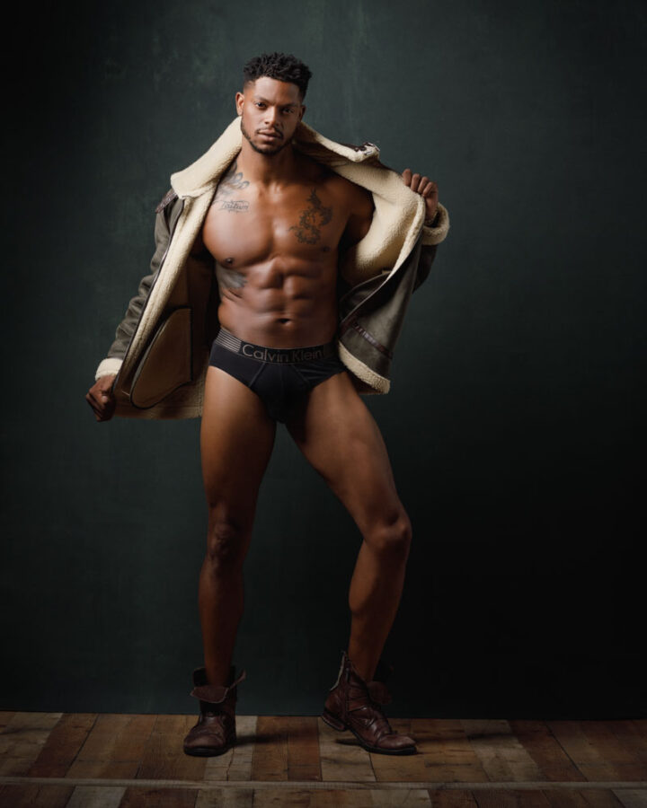 Chicago professional head shots of Jason wearing a green bomber jacket, emphasizing his athletic physique