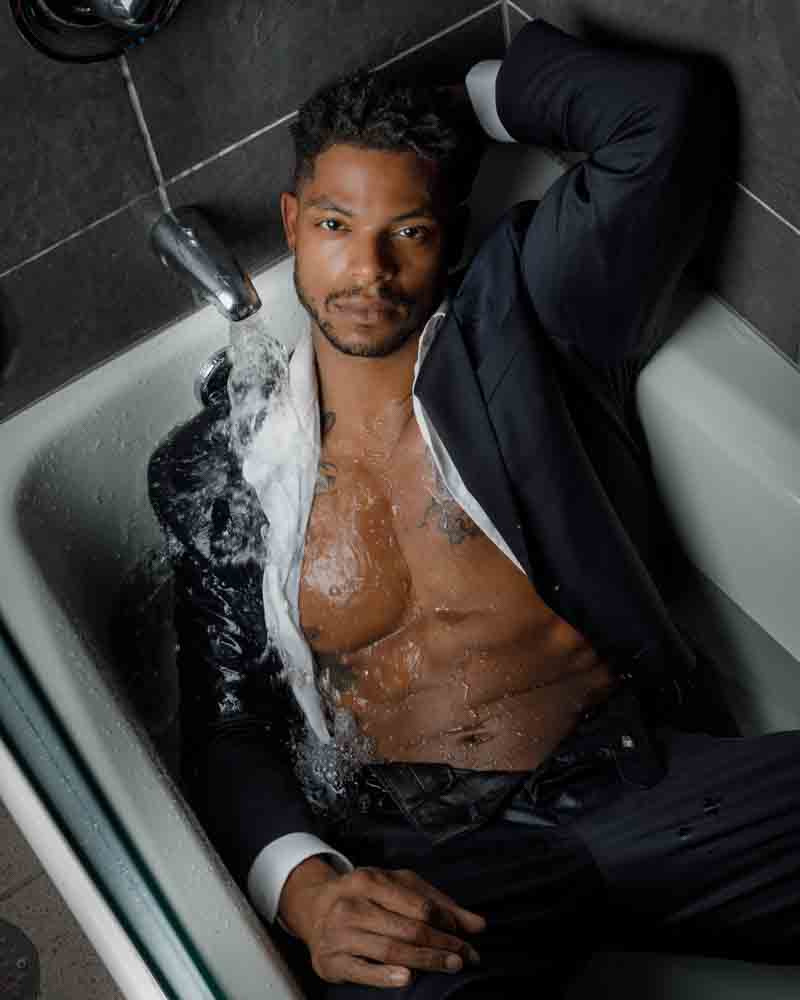 Dynamic Chicago professional headshotss in a creative setup, featuring model Jason in a suit in a bathtub