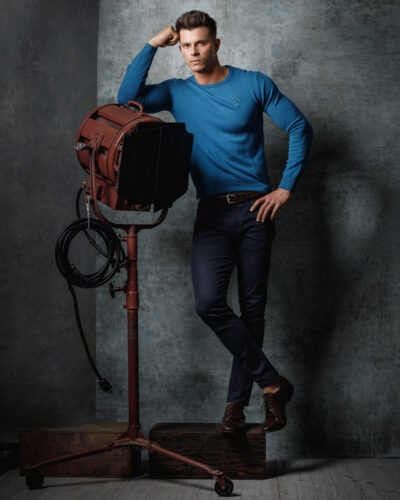 Kenny poses in blue jeans, showcasing the significance of full-length headshots in modeling. Captured by John Gress.