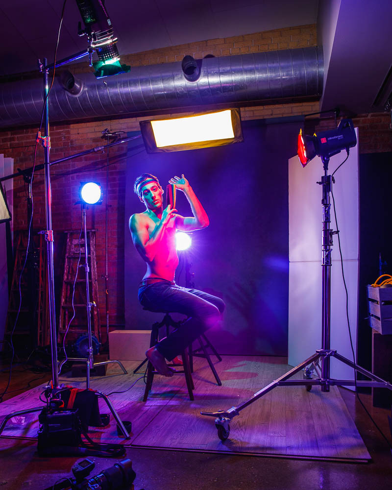 Behind the scenes of Editorial model photography in Chicago: Profile portrait of Marty in a spectrum of light from multiple colored gels