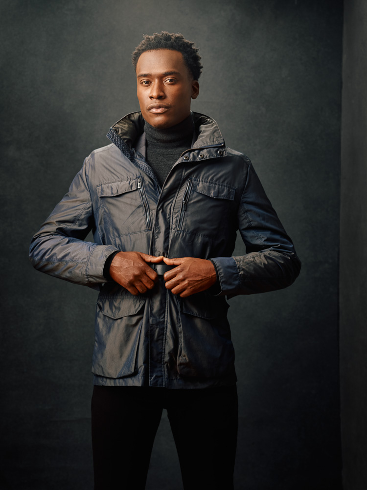 Model digital portfolio in Chicago - Justin in a gray coat and black jeans, striking an editorial pose