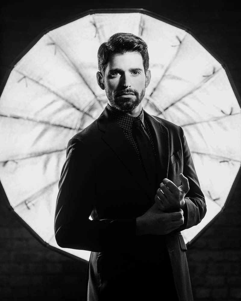 Jake in a black suit with beard during his model headshots in Chicago