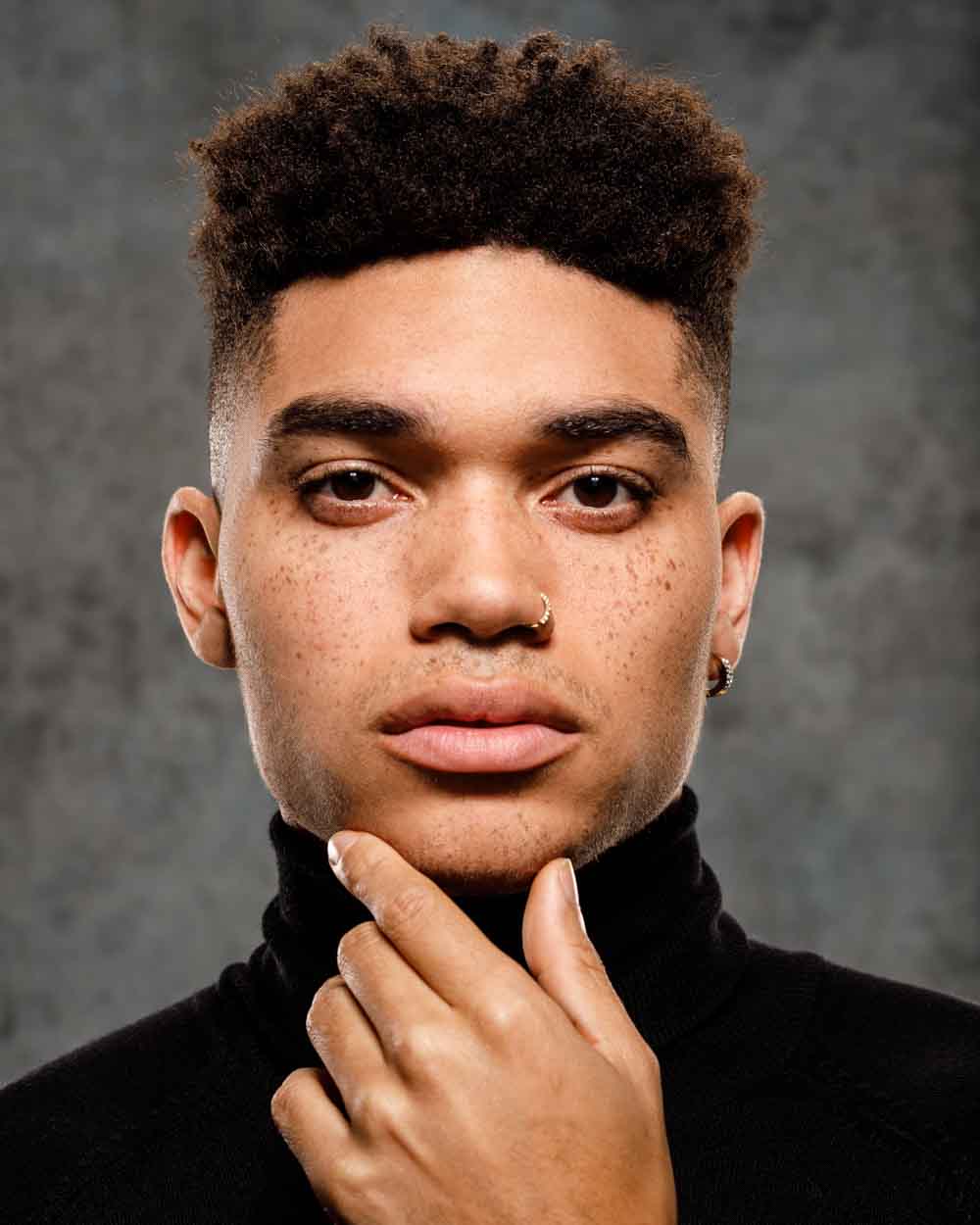 Ultra tight headshot of Kjay in a dramatic lighting setting, enhancing his features for a model headshot in Chicago