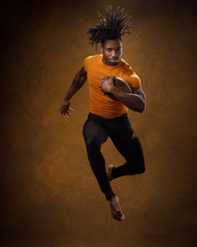 Dynamic action shot of Prince jumping, captured by John Gress in Chicago, highlighting athletic model portfolio photography.